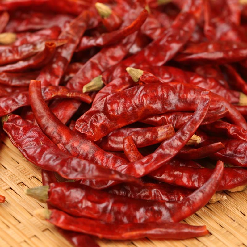 Xiaomila dried chili peppers heaped on a bamboo mat