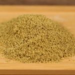 Ground fennel mounded on a wooden board
