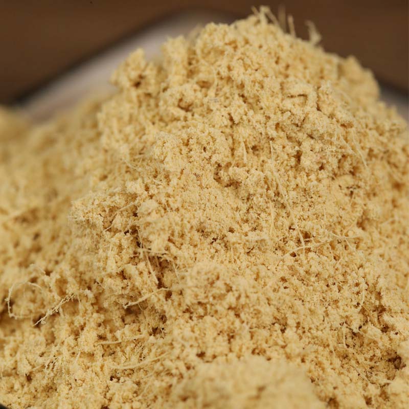 Ground ginger piled on a wooden board