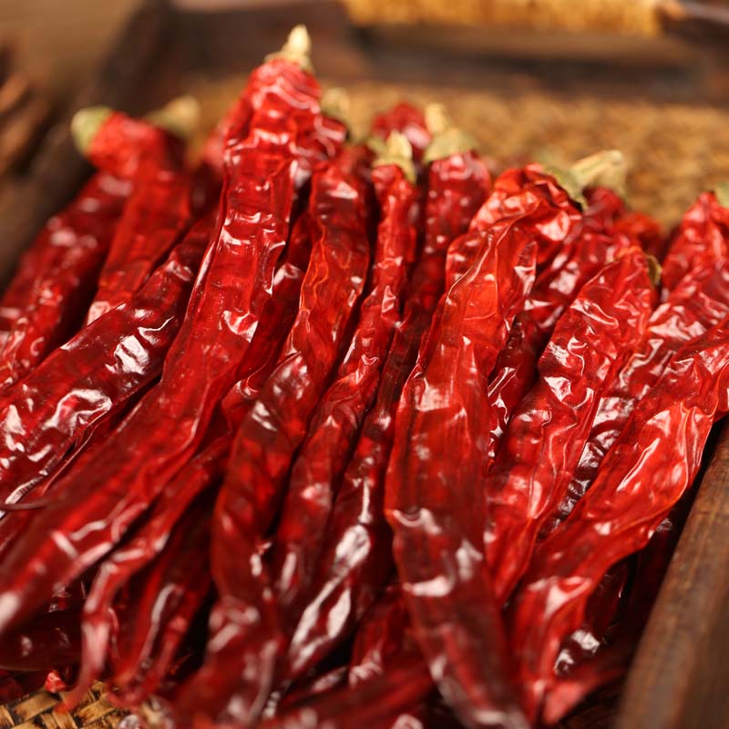 Erjingtiao dried chili peppers heaped on a bamboo mat