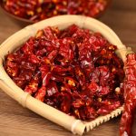 Erjingtiao dried chili segments filling a bamboo sieve