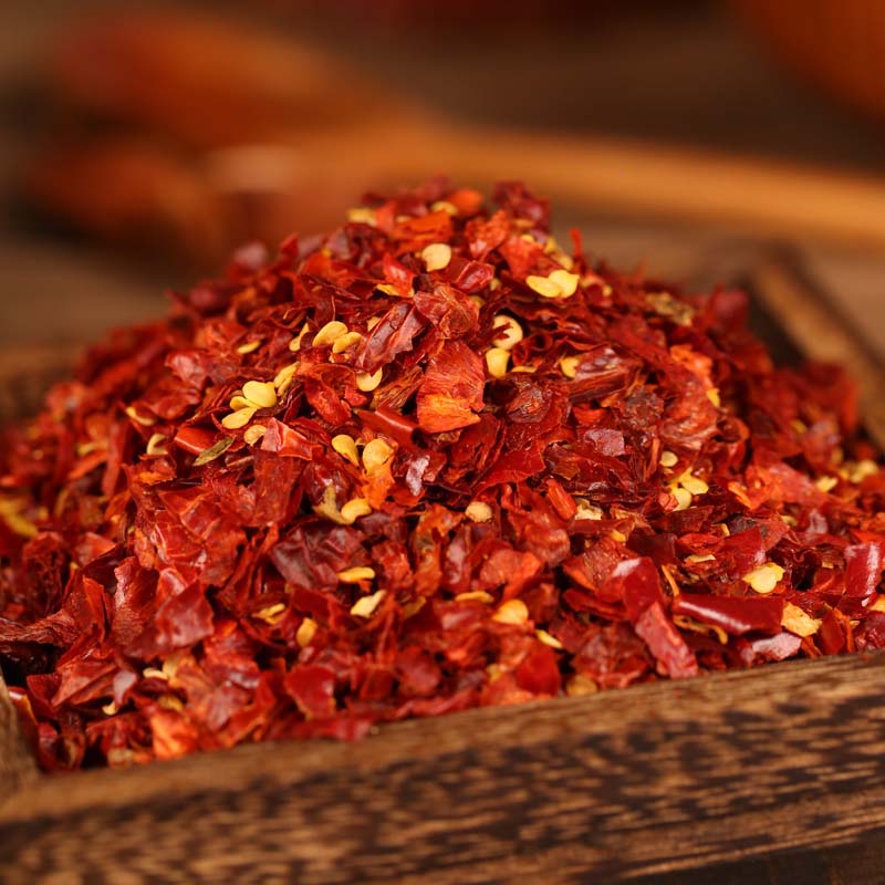 Xiaomila crushed chili flakes on a wooden tray