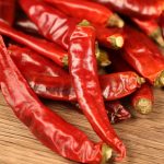 Huaxi dried chili peppers in close-up on a wooden table