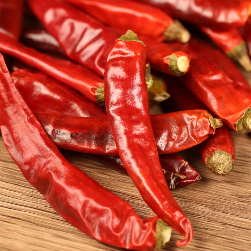 Huaxi dried chili peppers in close-up on a wooden table