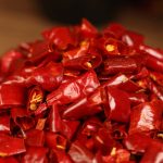 Xinyidai dried chili segments heaped on a wooden table